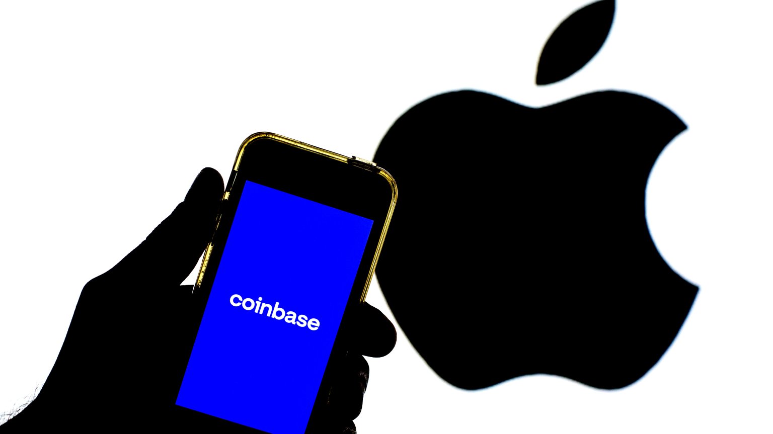 Coinbase on iPhone with Apple logo in the background