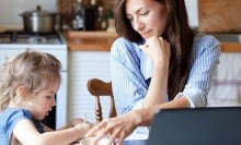 woman helping child at computer