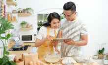 Two people looking at a tablet.