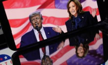 A photo of Harris and Trump on a phone screen with American flags and imagery reflected around them.