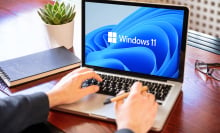 Man working with a laptop, Windows 11 new Microsoft operating system on computer screen