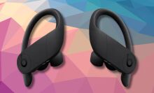 black beats powerbeats pro on a dark pink, tan, and dark blue geometric background