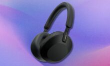 black sony wh1000xm5 headphones on a purple and pink gradient background