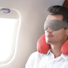 Person wearing the Bamboo Sleep Eye Mask on an airplane.