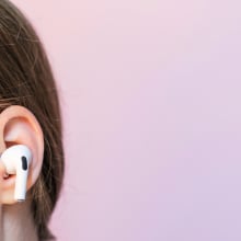 A woman wears an AirPod Pro 2.