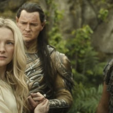 A still from "The Rings of Power" showing three elves gathered.