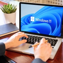 Man working with a laptop, Windows 11 new Microsoft operating system on computer screen