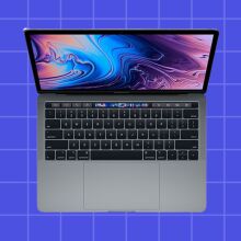 a 2019 MacBook Pro with touch bar on purple check background