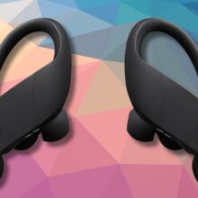 black beats powerbeats pro on a dark pink, tan, and dark blue geometric background