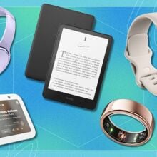 bose headphones, a kindle paperwhite, fitbit fitness tracker, and oura ring on a blue and turquoise background