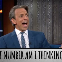 A man in a suit gestures on a talk show with his mouth open. The caption at the bottom reads, "What number am I thinking of?"