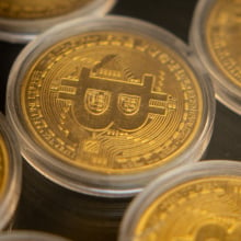 Gold coins with the Bitcoin "B" stamped on them.