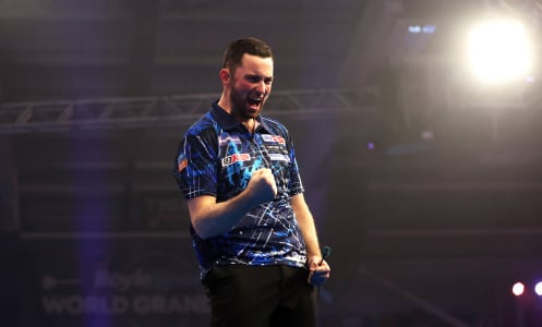 Luke Humphries of England celebrates victory