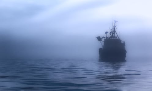 A ship amid the fog in the ocean