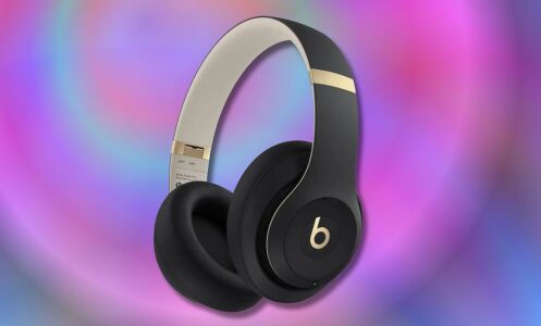 black and gold beats studio pro headphones on a purple and pink background