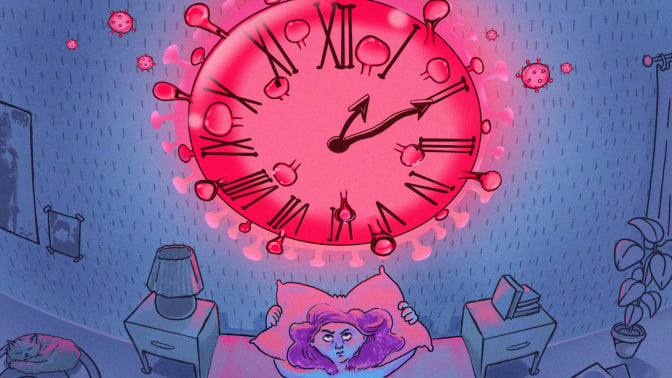 A woman lays in bed staring at a clock that looks like the COVID virus. 