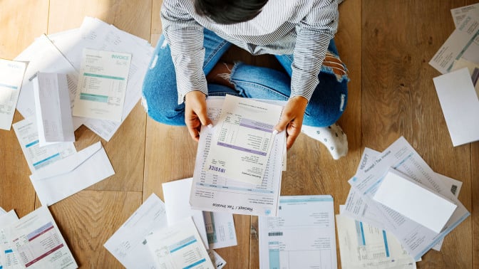 person doing their taxes on the floor