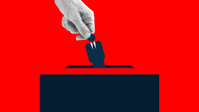 Human hand placing an icon of man wearing suit into the voting box.