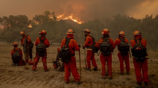 Firefighters battle the Mountain Fire in Moorpark, Calif.