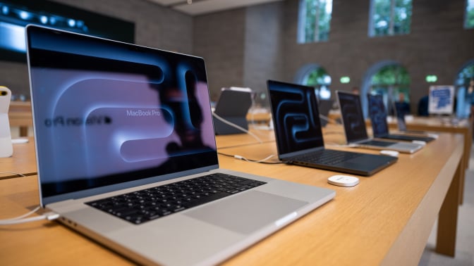 Numerous MacBook Pro laptops are on display in the Apple store on Kurfürstendamm