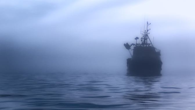 A ship amid the fog in the ocean