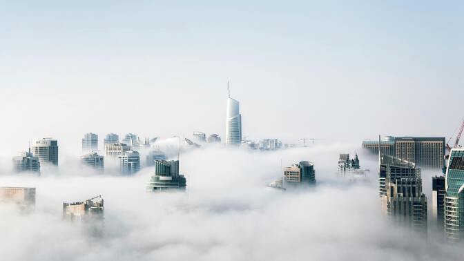 the new york city skyline shrouded in clouds