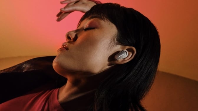 person laying back with eyes closed wearing bose quietcomfort ultra headphones