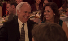 A man (Robert Pine as Gerald Halpert) and a woman (Perry Smith as Betsy Halpert) sitting at a dinner table in the "Niagara" episode of "The Office."