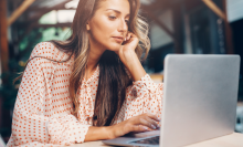 woman browsing the web on laptop in public