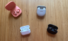 Four pairs of earbuds sitting on a table