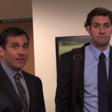 A screenshot of two men, Steve Carell as Michael Scott and John Krasinski as Jim Halpert, from an episode of "The Office." One of the men, Carell, is soaking wet from an accidental fall in a koi pond.