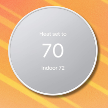 Google Nest Thermostat on orange and white background