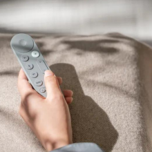 Google TV streamer remote in a person's hand 