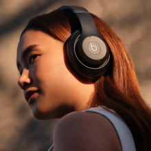 a close-up of a woman wearing beats studio pro headphones