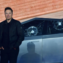 Tesla co-founder and CEO Elon Musk stands in front of the shattered windows of the newly unveiled all-electric battery-powered Tesla's Cybertruck at Tesla Design Center in Hawthorne, California on November 21, 2019.