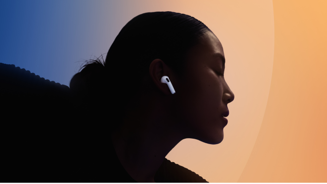 a close-up of a woman wearing apple airpods 4 against a blue and orange background