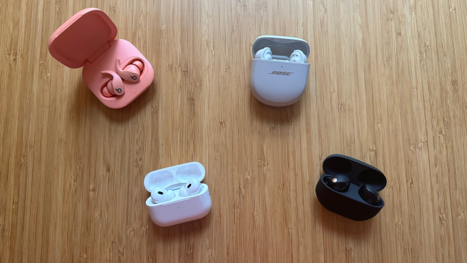 Four pairs of earbuds sitting on a table