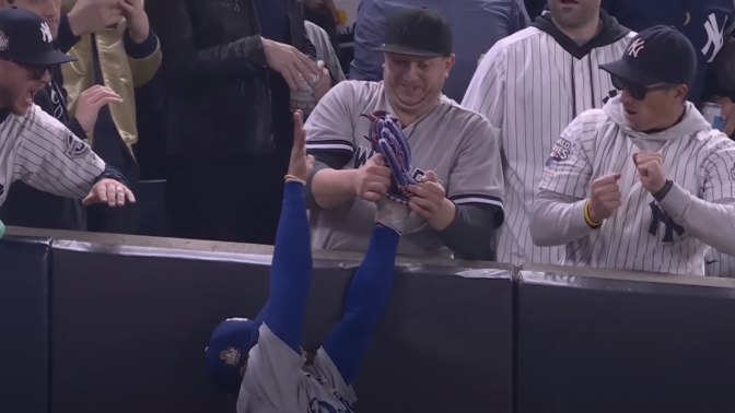 yankee fan taking ball from mookie betts