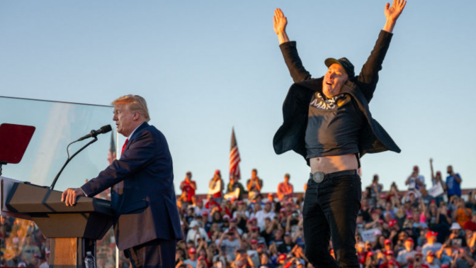 Tesla CEO Elon Musk (R) jumps on stage as he joins former US President and Republican presidential candidate Donald Trump during a campaign rally in Butler, Pennsylvania on October 5, 2024. 