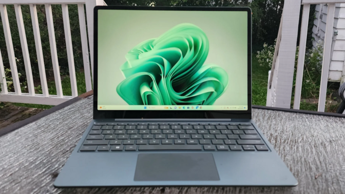 microsoft surface laptop go 3 on a patio table outside on a deck